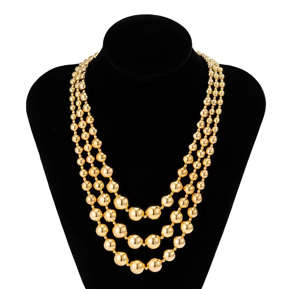 Fantastique tour de cou en perles d'or et bracelet assorti